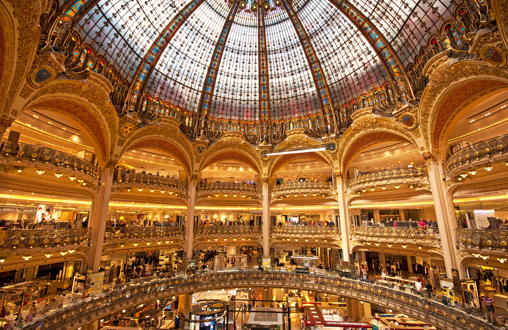 Inside the glass-domed Galleries Lafayette with many shops.