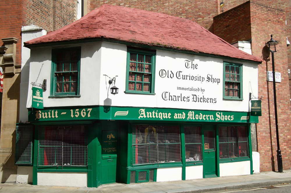 Exterior of the green and white Old Curiosity Shop in London.