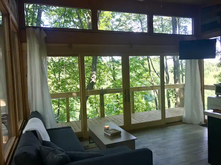 View out living room into Hocking Hills forested outdoors