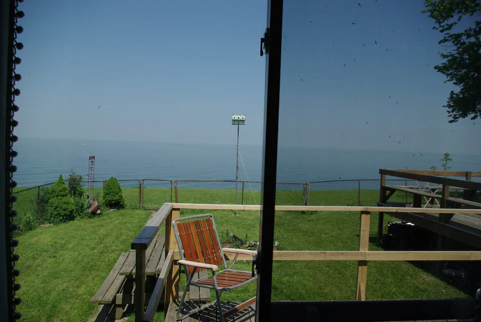 Sit back and relax on the back balcony and watch the sun set at this Lake Erie Airbnb