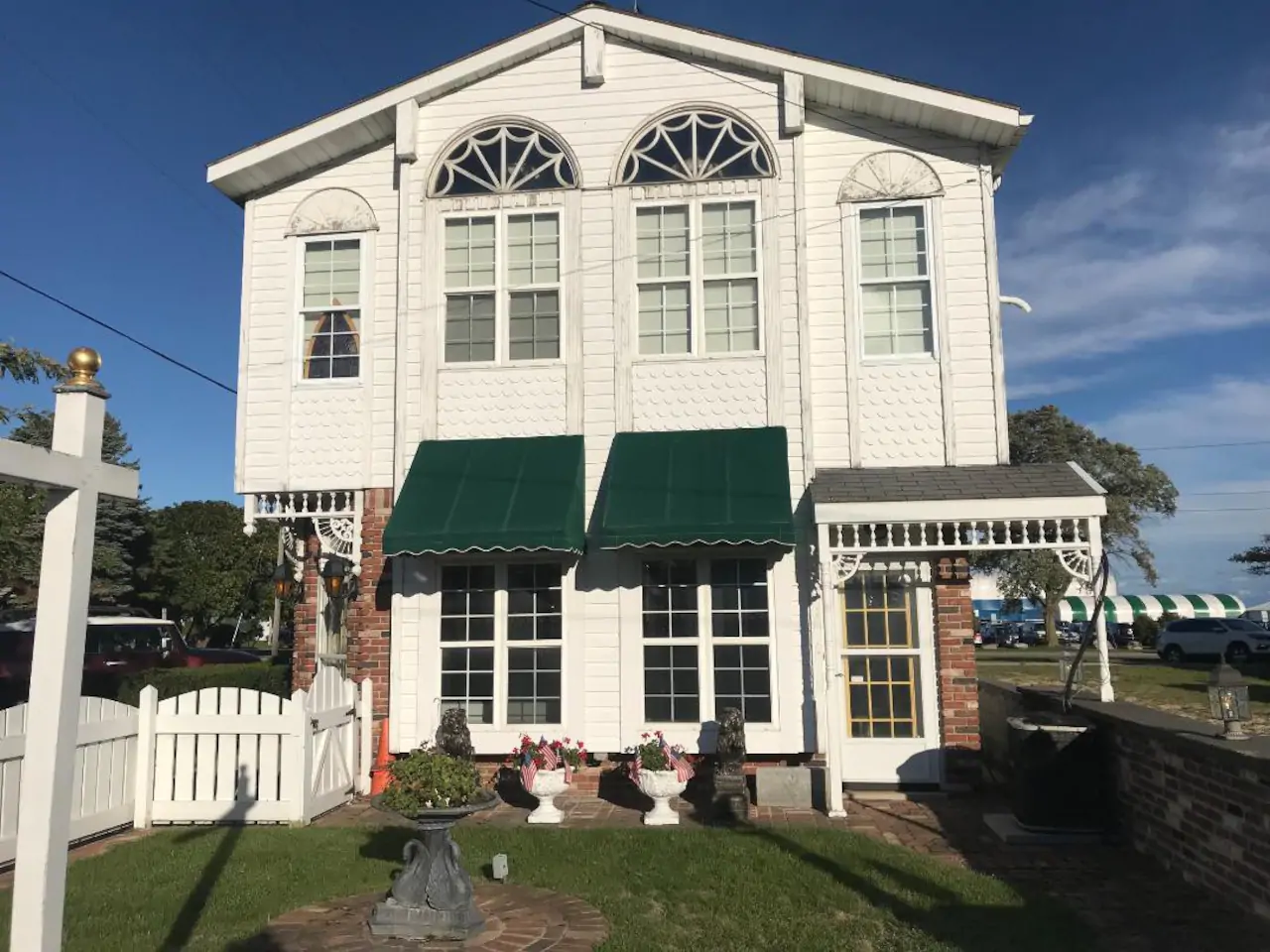 Beautiful historic building with white facade and green awnings