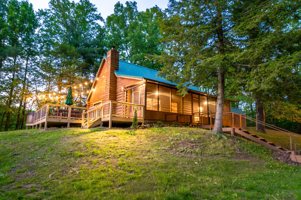 Timbered log cabin high on a hill with lights makes this a great cabin for rent in Indiana.