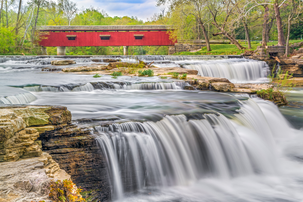 Red Cataract Bridge over rushing stream in Indiana