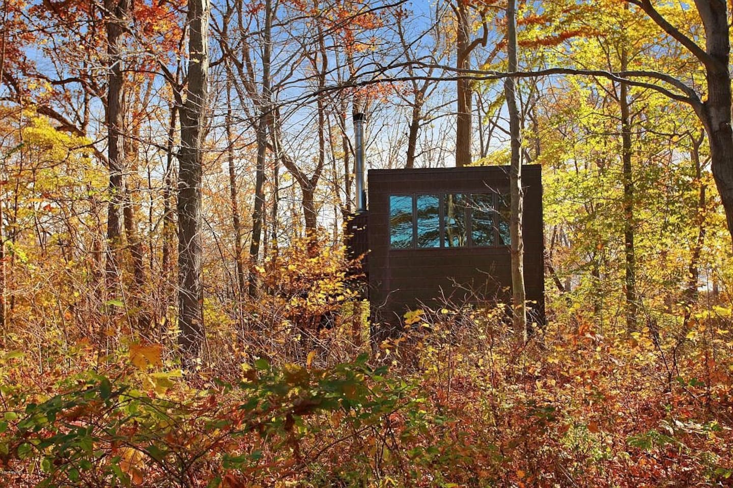 Cabin in Indiana surrounded by autumn foliage