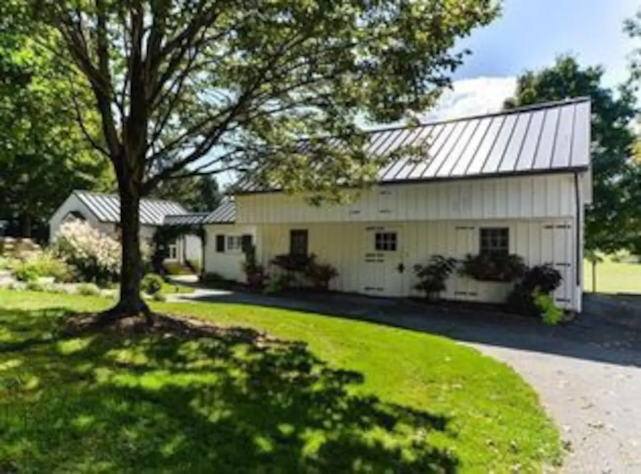 White barn with beautiful planters around it is a charming Pennsylvania Airbnb