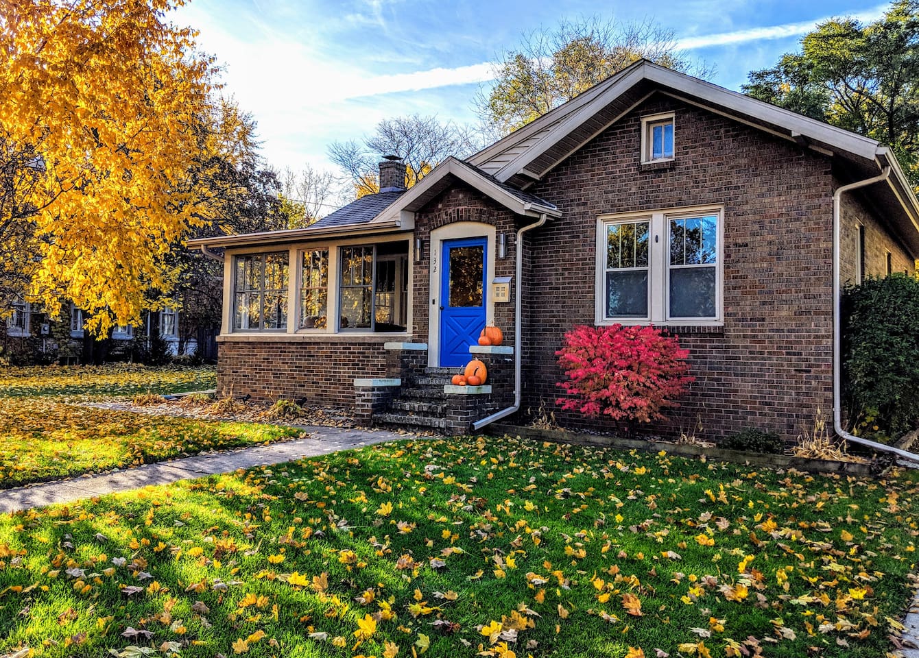 Modern 1920s Bungalow decorated with autumn foliage and pumpkins. It's one of the best Airbnbs in Wisconsin.