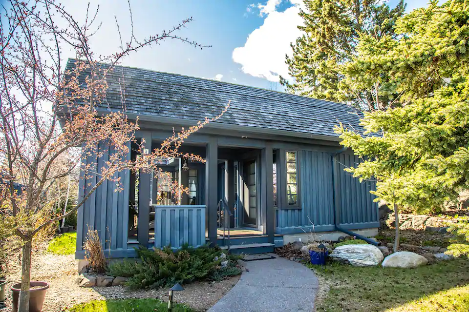 Charming blue Northern Minnesota cabin rental with lots of windows to let the light in on a bright sunny day.