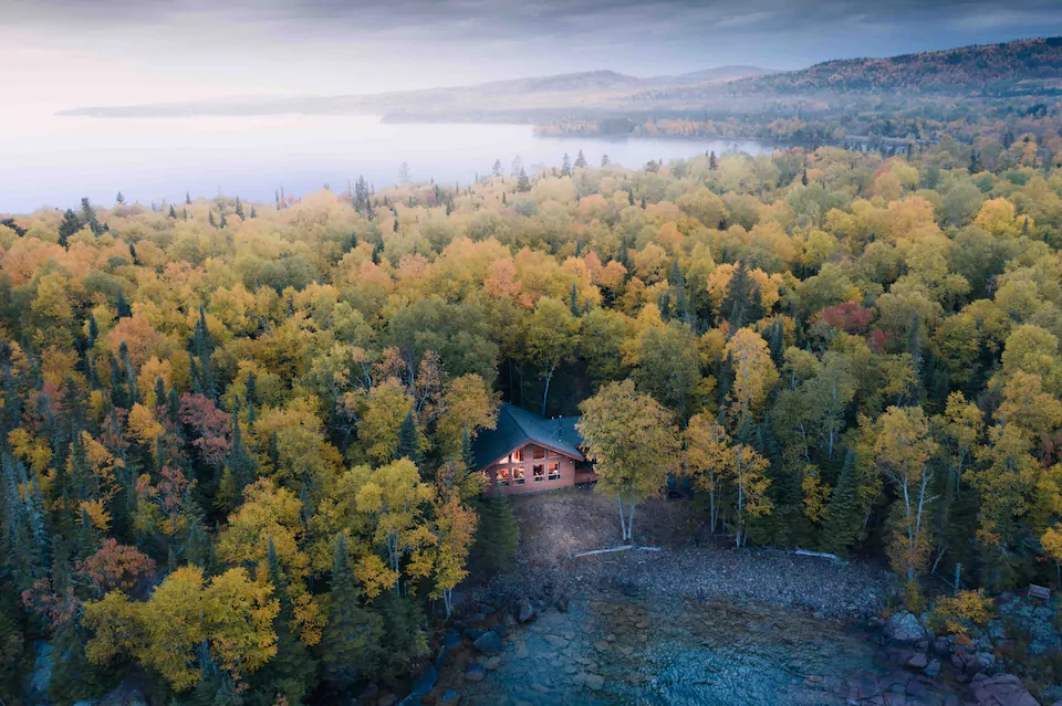 Overhead photo of northern Minnesota cabin rental surrounded by trees on a beautiful cove of Lake Superior.