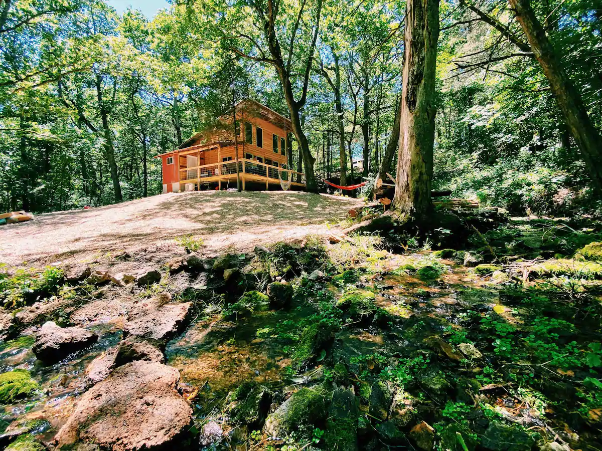 Photo of wooden house surrounded by woods.