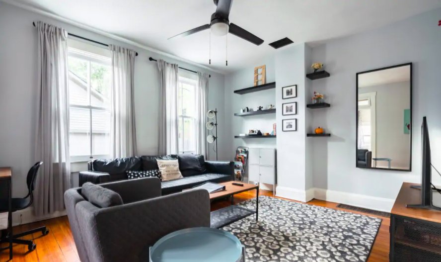 bright, modern interior of home with black couch