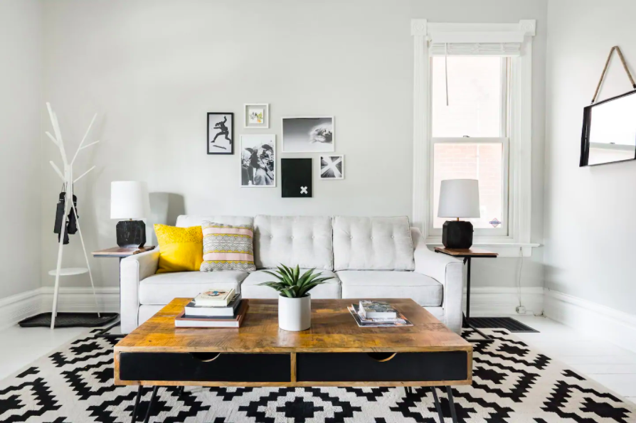 white couch with yellow pillow and wooden table best Airbnbs in Columbus
