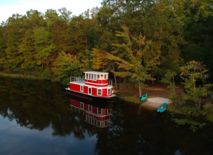 red and white tugboat in lake