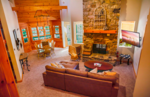 living room area of cabin with stone fireplace