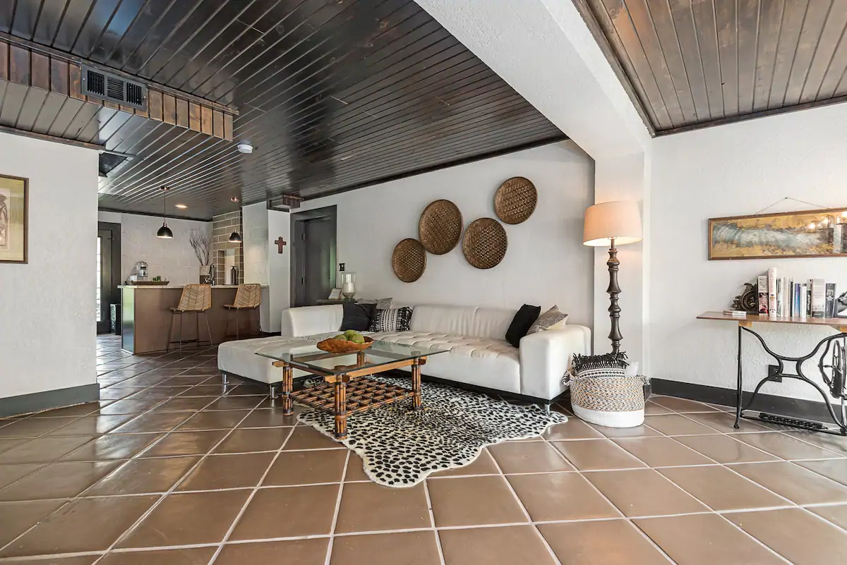 Exceptionally beautiful living space with tiled floors and wooden planked ceiling. 