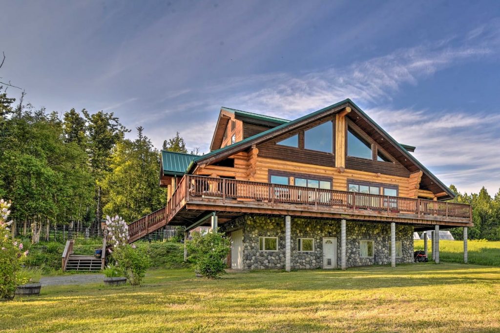 One of the best cabins in Alaska this photo is of cabin with wood upper level and stonework on ground floor. Large windows and lots large yard.