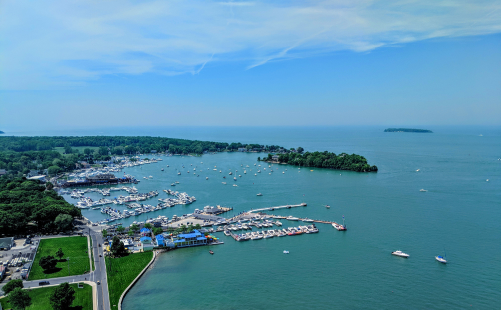 The aerial view of South Bass Island one of the best beaches in Ohio where you can see a boating marina and grassy beaches