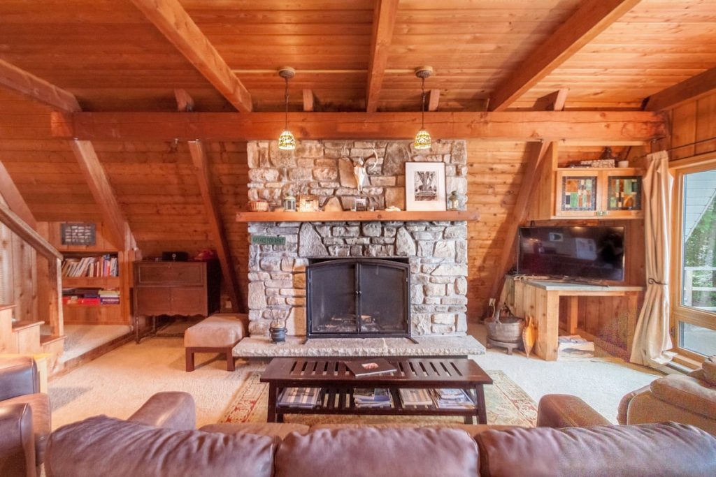 Spectacular living space with plant walls and ceiling and large stone fireplace.