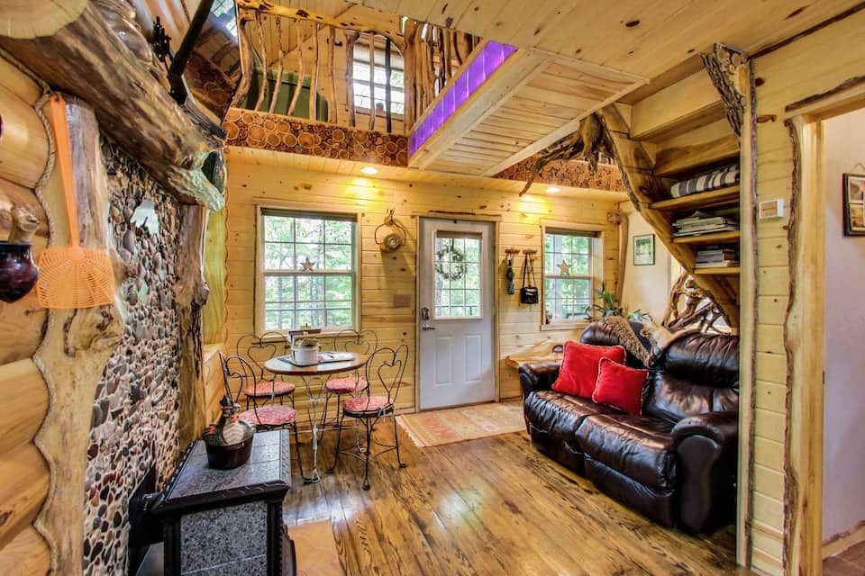 Cozy chic living space of one of the best cabins in Wisconsin with knotty pine walls and plank wooden floors.