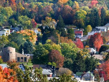 Small Pennsylvania town nestled into hillside with bright autumn colored leaves