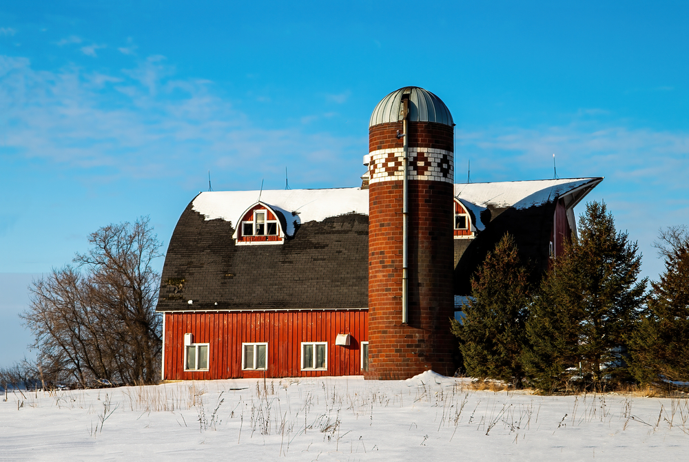 A barn in Scandia Minnesota that has a quilt pattern in the bricks of the silo