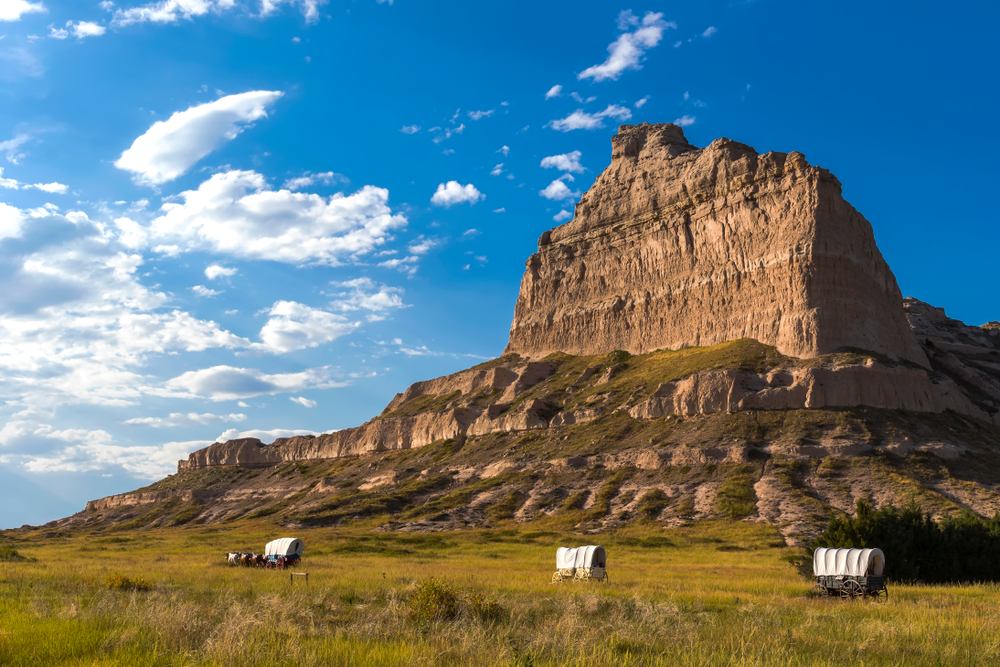 The Scotts Bluff National Monument with classic prairie wagons in front of it in Nebraska