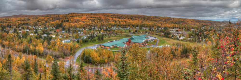 An aerial view of Silver Bay Minnesota in the fall surrounded by trees with leaves changing colors.