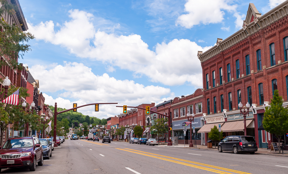 Picturesque downtown Franklin, a small PA town with red brick vintage building and cars parked in street.