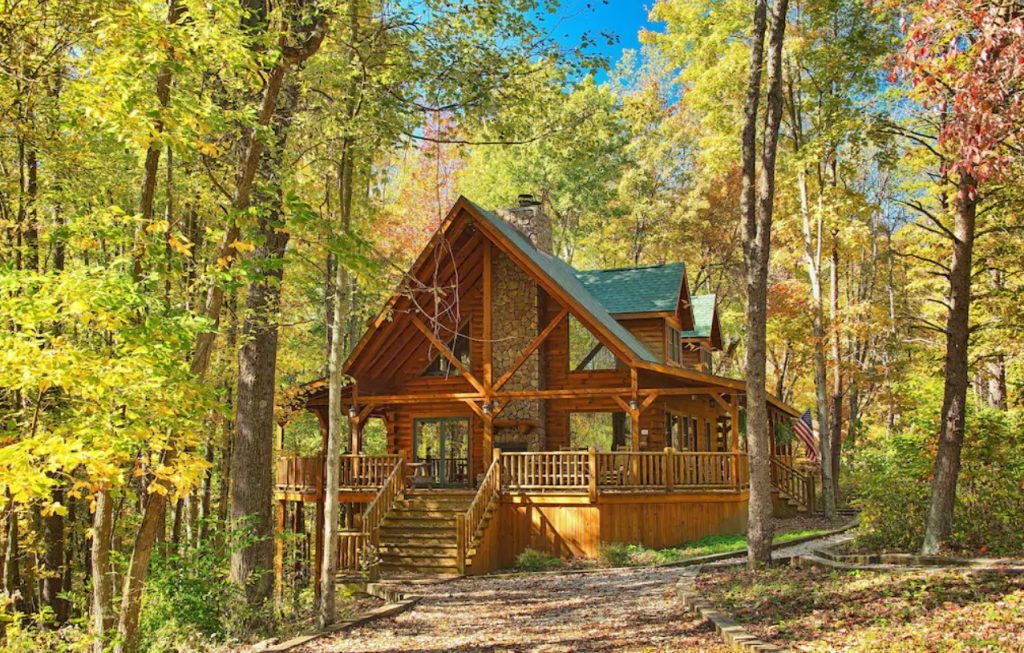 The exterior of a large log cabin near Hocking Hills State Park at the beginning of fall, a VRBO in Ohio