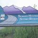 Blue and purple Alaska road sign signaling Anchorage to Seward
