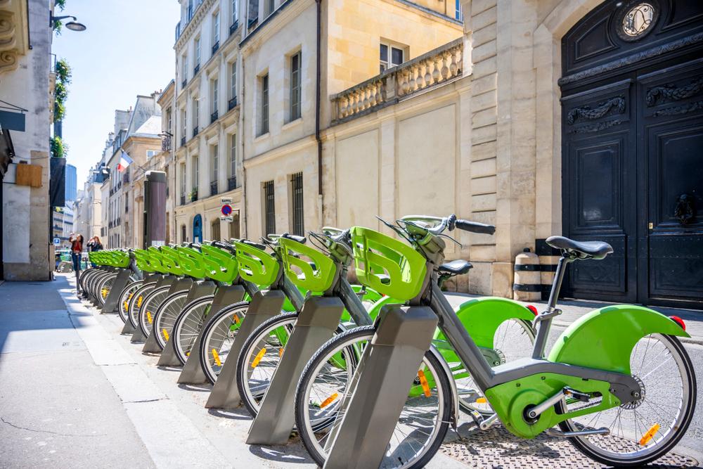 Green bicycles on stands ready to be rented. A great way to get around Paris. 