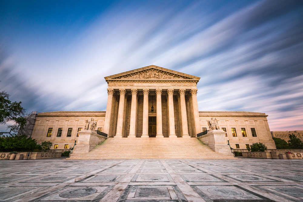 Front of the U.S. Supreme Court with clouds streaking the sky.