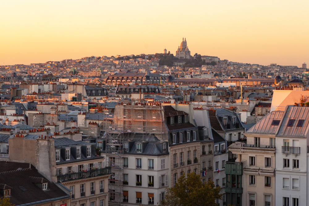 Orange sunset over Paris with the Sacre Couer in the distance.