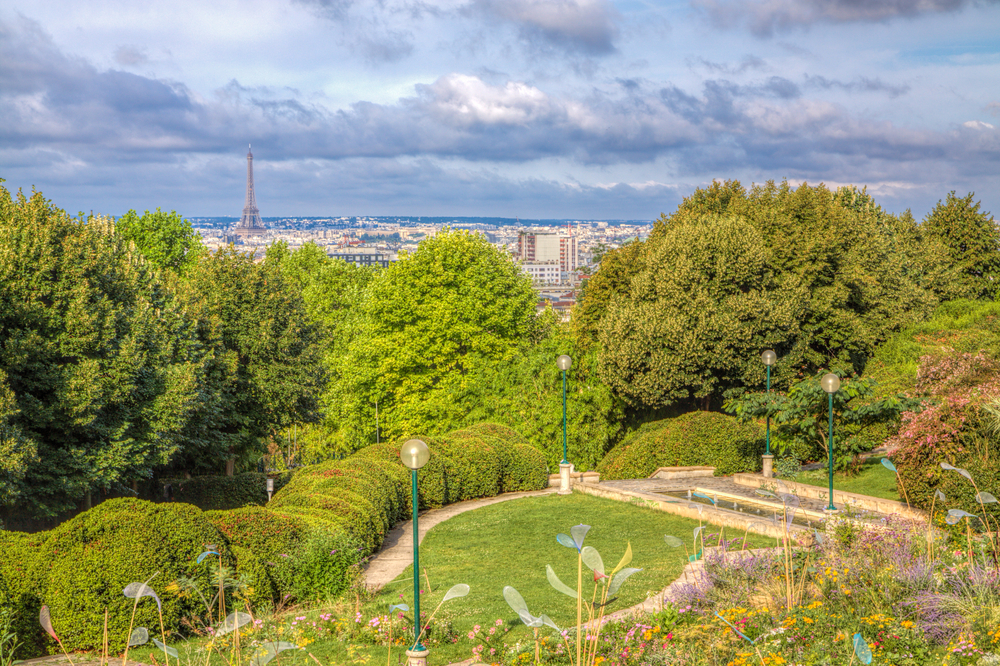 View over the greenery of Parc de Belleville with the city in the distance.