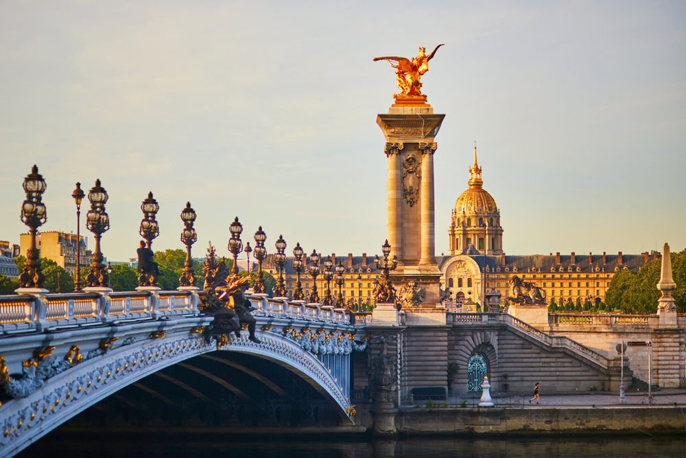 Golden hour over the Pont Alexandre III with its intricate lampposts and gold accents.