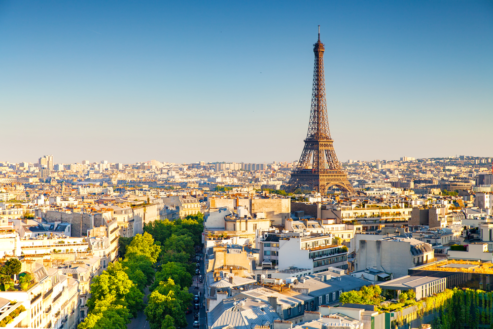 View from the Arc De Triomphe featuring the Eiffel Tower and rooftops.