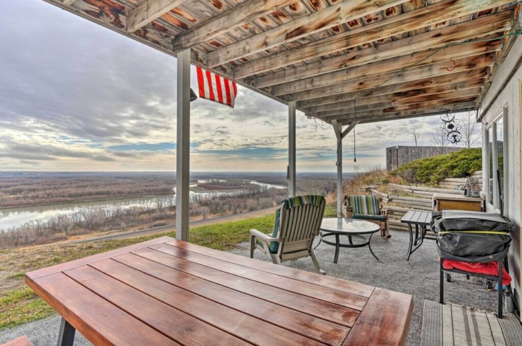 The deck of one of the best Airbnbs in North Dakota that looks out on the Missouri River on a cloudy day