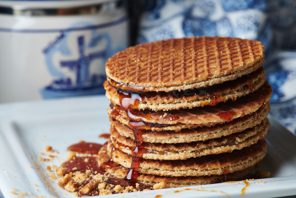 Round brown pancakes filled with caramel and drizzled with maple syrup.