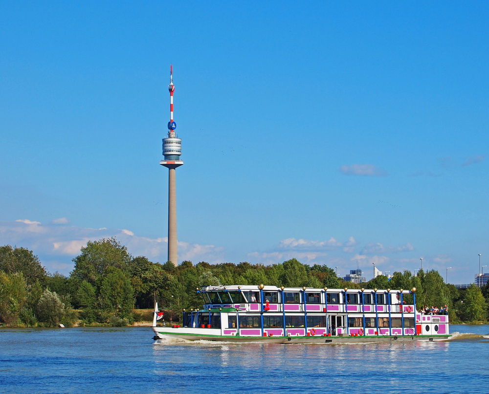 A view of the Danube Tower and a cruise boat on the Danube River