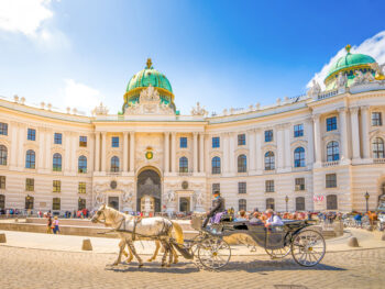 A horse drawn carriage infront of the Hofburg Palace one of the best things to do in Vienna