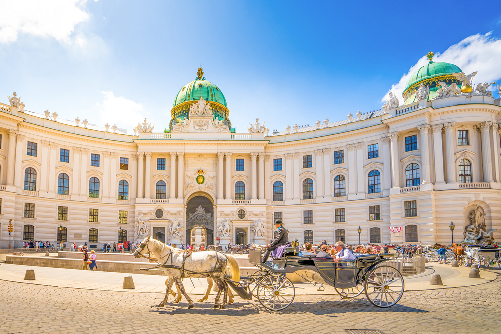 A horse drawn carriage infront of the Hofburg Palace one of the best things to do in Vienna