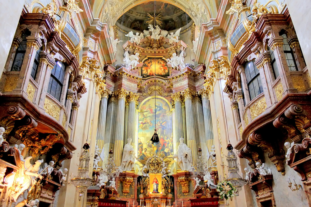 The interior of the St. Peter's Church in Vienna. It's elaborately decorated with baroque and rococo architecture and art.