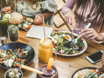 white females eating salads during brunch in London
