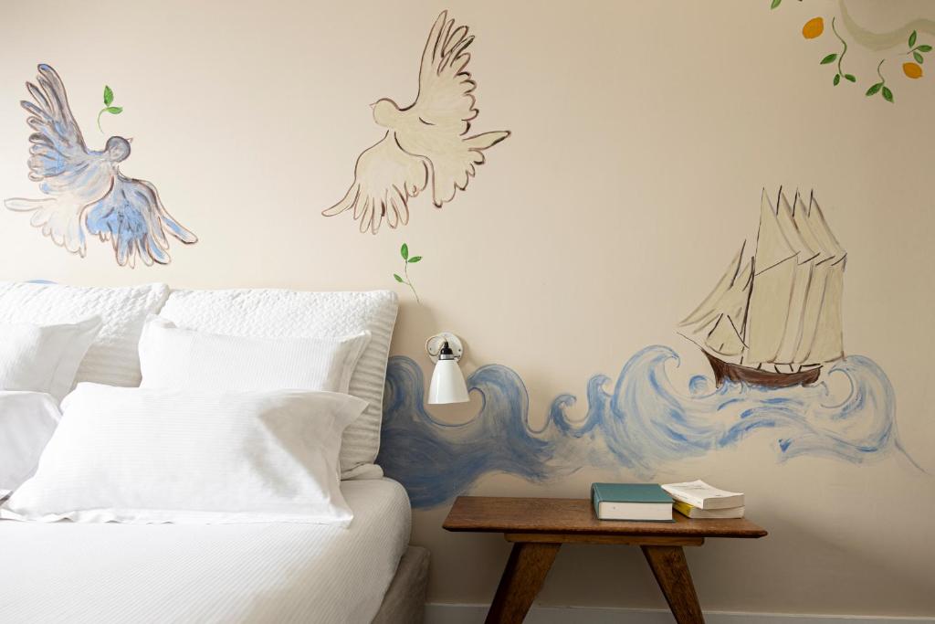 A beautiful bedroom of one of the boutique hotels in Paris. The walls is painted with birds and flowers. 