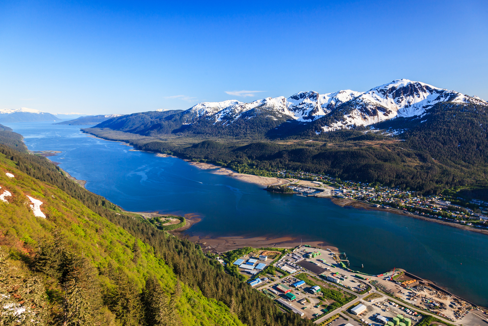 Aerial view of Juneau and the Gastineau Channel with snow capped mountains in the distance.