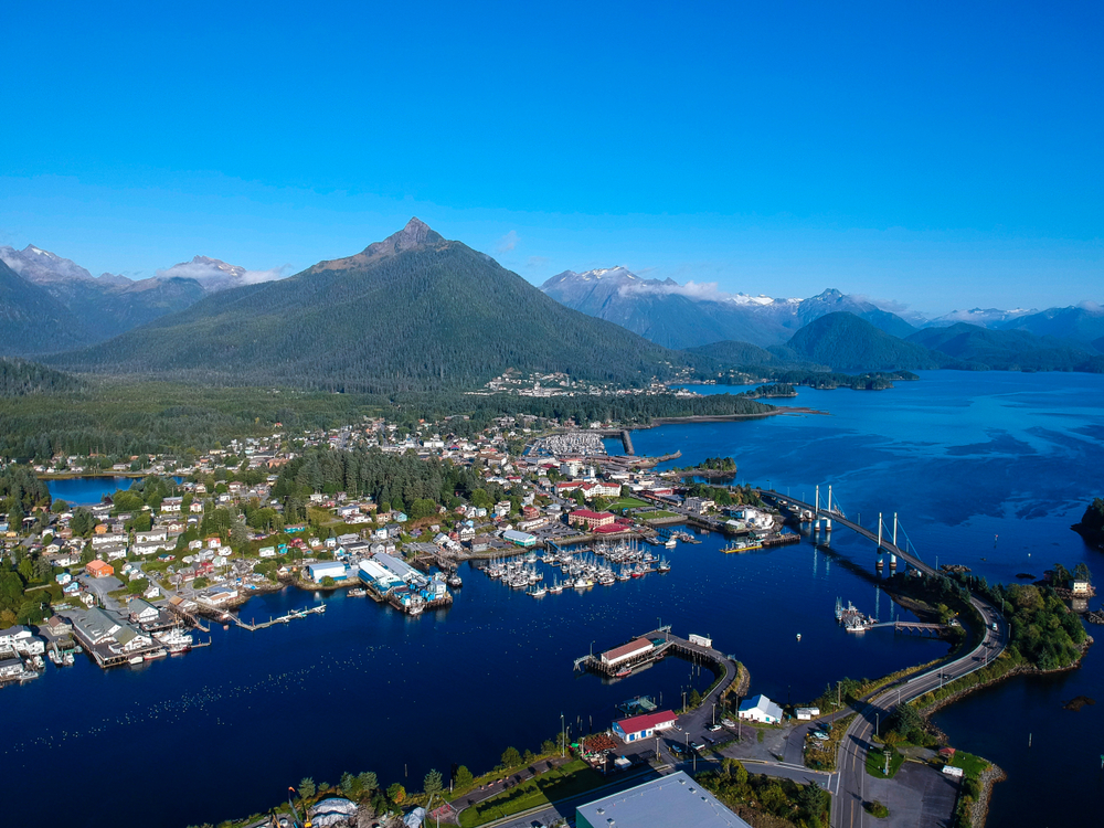 Aerial view of Sitka nestled between green mountains and the water.