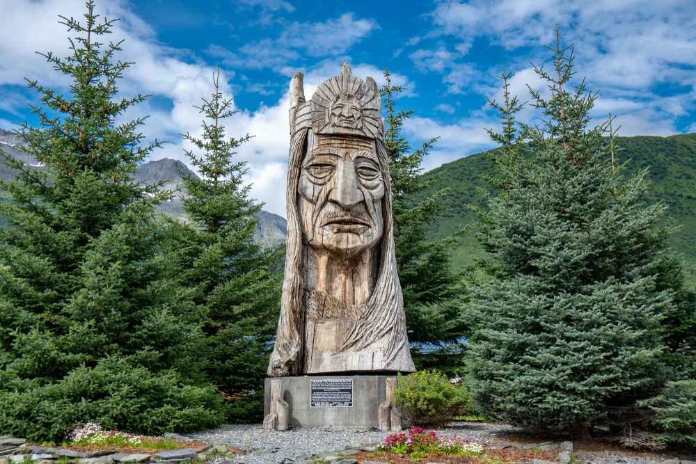 Big, carved totem of a Native Alaskan man.