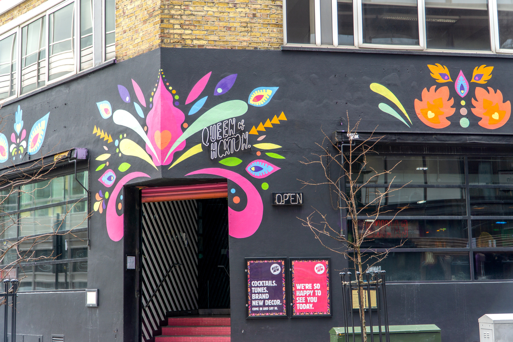  Queen of Hoxton rooftop bar entrance, Curtain Road, Shoreditch, East London. The building is black with decoration on. 