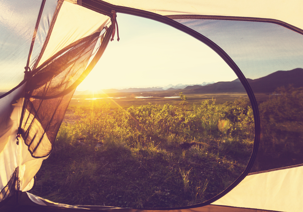 View out of a tent looking over the mountains.