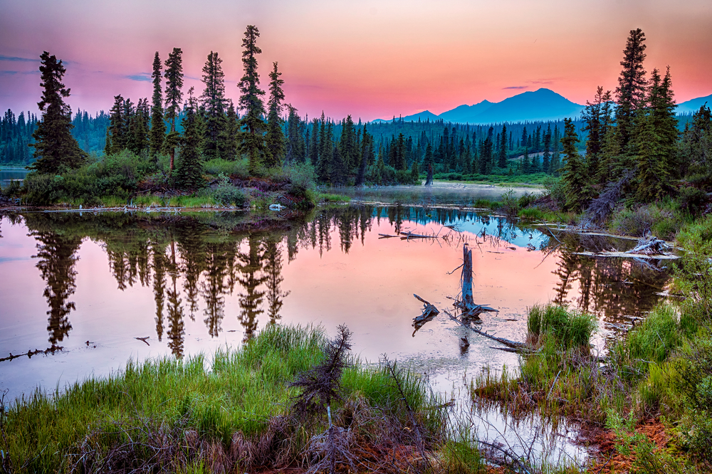 Pink sunset over a lake in Alaska in May.