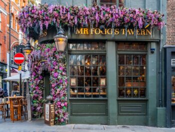 this bar in Covent Garden has purple flowers surrounding the front door.